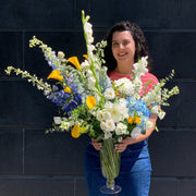 Tall White flowers -- delphinium with a mix of gladiolus, Yellow Calla, Hints of Blue, White Rose. Tall stately Vase