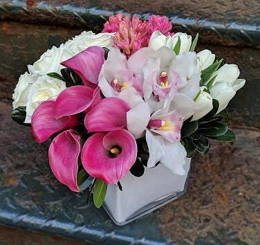 pink Calla Lilies, white Cymbidium Orchids, pink fragrant Hyacinth, and white Tulips