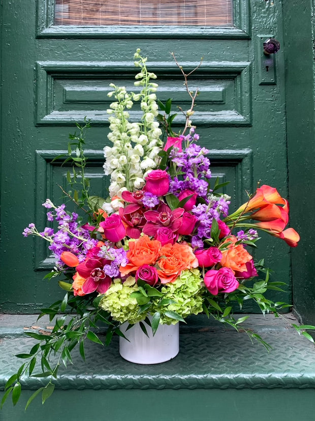 delphinium, orchids, stock flower, roses, callas, dahlia or garden rose, hydrangea, and a mix of interesting greenery