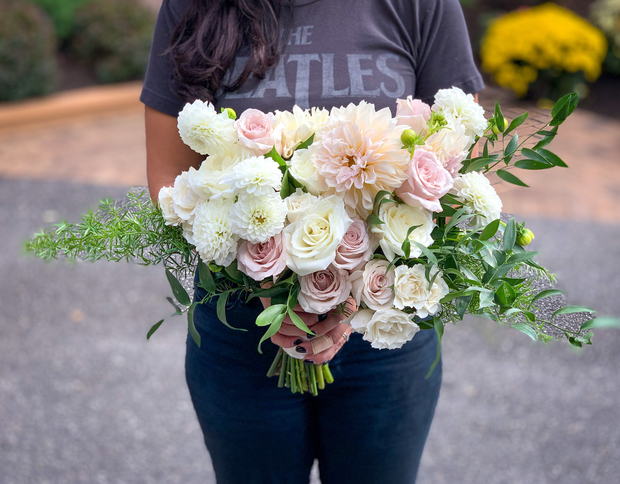 roses, spray roses, and seasonal dahlia with delicate greenery