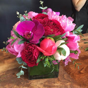 Fuchsia Orchids, Mix Of Pink and White Roses, Pink Peony, and Eucalyptus accents.
