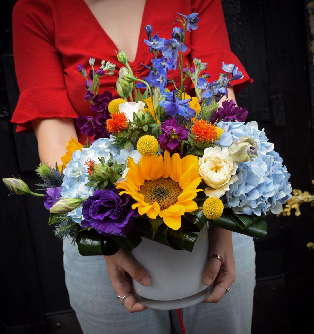 sunflowers, hydrangea, delphinium, stock, lisianthus, and mixed wildflowers
