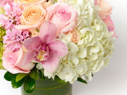 Peach Roses, pink Roses, peach spray Roses, white and green Hydrangea, and pink Cymbidium Orchids