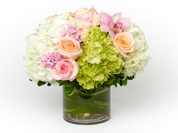 Peach Roses, pink Roses, peach spray Roses, white and green Hydrangea, and pink Cymbidium Orchids
