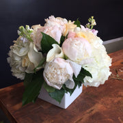 A blend of pastels in blush, light yellow, creams, and whites. Includes a variety of Roses, Peony, Stock, Hydrangea, and Calla.