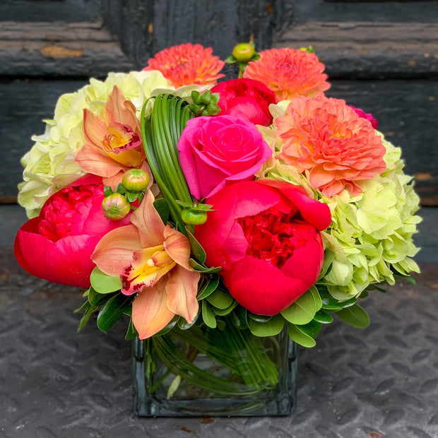 dahlias, roses, orchids, and hydrangeas, with a modern lily grass loop accent