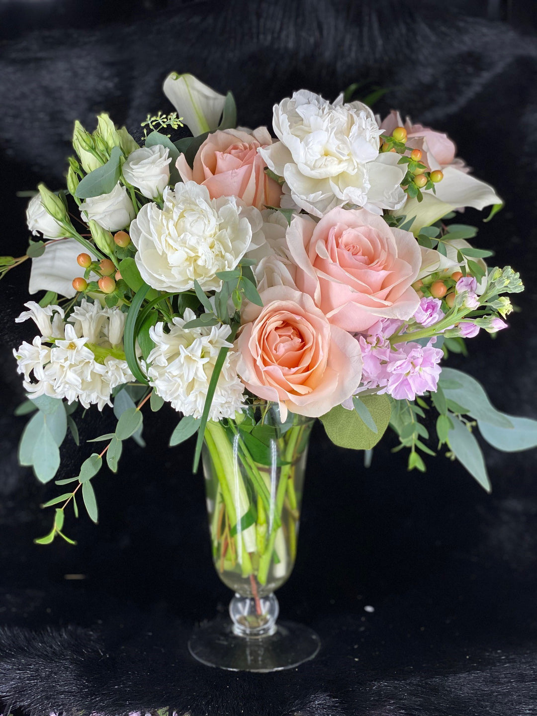 peach rose, hypericum berry, white hyacinth, lisianthus, peony, calla lily, and pink stock flower