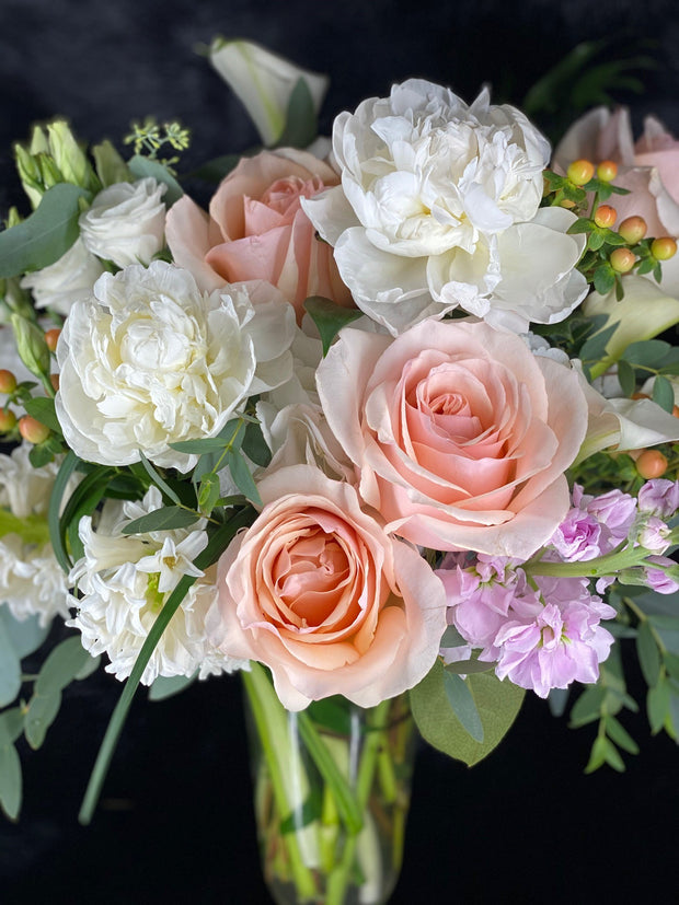 peach rose, hypericum berry, white hyacinth, lisianthus, peony, calla lily, and pink stock flower