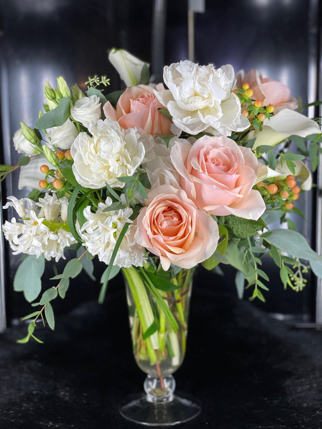 peach rose, hypericum berry, white hyacinth, lisianthus, peony, calla lily, and pink stock flower