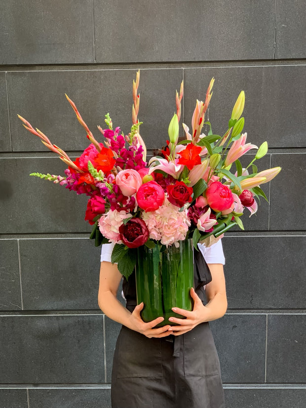 Pink, Red, and Hot Pink Flowers in a tall vase