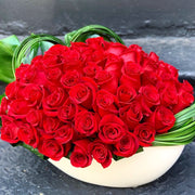 Dozens of Roses designed tightly in an oval container 
