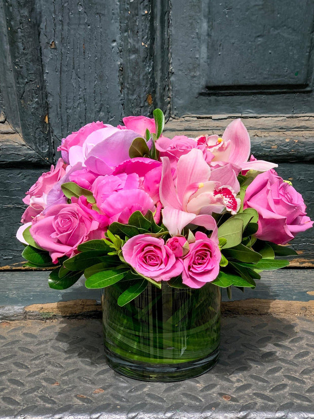 pink flowers including peony, orchids, and roses
